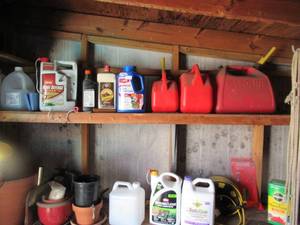 lot 193 image: GAS CANS, EXTENSION CORD WITH REEL, PESTISIDES, PLANT FOOD, 2 STEP STOOLS, VARIOUS SIZED PLANTERS AND MORE
