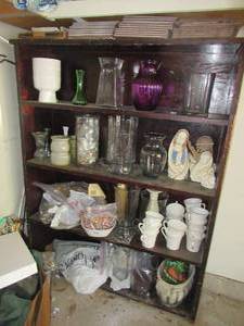 lot 211 image: WOOD STORAGE SHELF 38 X 10 X 49 WITH CONTENTS. VASES, CERAMIC RELIGIOUS FIGURES AND MIKASA COFFEE CUPS THAT GO WITH DISHES INSIDE THE HOUSE