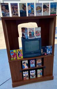 lot 16 image: TV StandCabinet, Sharp TVVCR Combo Model #13VT-L100 and 21 VHS Movies