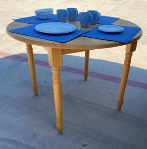 lot 40 image: Coaster Table and 20 piece Corelle Country Cottage Dishes with matching placemats
