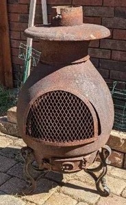 lot 4 image: Antique Cast Iron Chiminea with cast iron legs. Legs might not be original. 38 tall and about 17 wide. Heavy Item