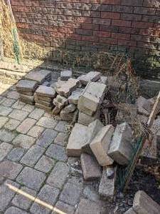 lot 10 image: Loose Stones including border stones and garden fencing, does not include stones embedded in the ground. About 25 feet of fencing with poles.