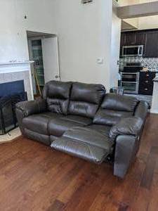 lot 12 image: Brown Couch,  the two ends are electric recliner seats, possible leather. Measures 91 inches long and when recliners are fully extended it is about 65 inches wide.