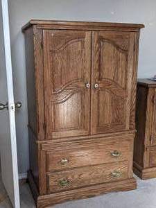 lot 31 image: Pacific Frames Ind. Wood entertainment center with two drawers. Approximately 62inches, 37 inches wide and 20 inches deep. Item is on the second floor. Bring your own movers.