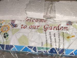 lot 99 image: Mosaic Welcome Bench, New in Box.  Approximately 17 inches long by 8inches tall