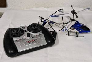 lot 114 image: GYRO Gyroscopes Systems Helicopter with remote which needs batteries and the charging cable is included.