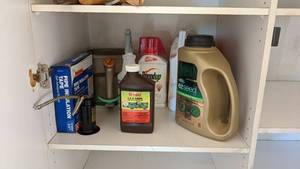 lot 127 image: Contents of the self to include RoundUp, Easy Seed, and a nice Oil Can