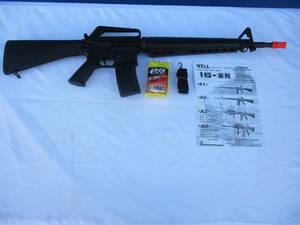 lot 13 image: M-16 A2 Spring Airsoft Rifle With Clip, Strap And Bag Of 1,000 0.12g Yellow BBs, In Box