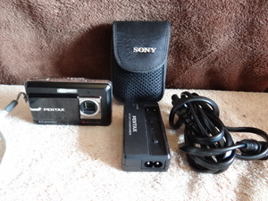 lot 34 image: Pentax Optio Z10 8MP Digital Camera with 7x Optical Zoom wCharger & Case