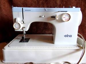 lot 245 image: ELNA SUPER SEWING MACHINE - MADE IN SWITZERLAND IN ORIGINAL STAORAGE CASE WITH PEDAL - TESTEDWORKS