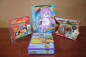 lot 205 image: Cranium Wonder Works, Talking and Teaching Telephone, Care Bear and Rip Stick Racer Mater from Cars (ALL STILL IN PACKAGING)