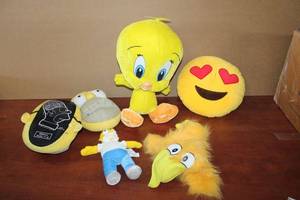 lot 208 image: Yellow Lot Homer Simpson Slippers, Plush Homer, Plush Tweedie Bird, Love Emoji Pillow, and Bird Puppet