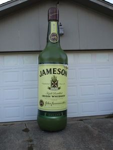 lot 4 image: VERY LARGE 16 FT INFLATABLE. JAMESON IRISH WHISKEY BOTTLE. BUILT IN FAN WITH CORD SO IT STAYS INFLATED, WORKS GREAT