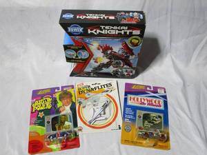 lot 266 image: TENKAI KNIGHTS NIB, UNOPENED 1983 SUPER DYNA FLIGHTS PLANE, 2 UNOPENED HOLLYWOOD ON WHEELS, THE PARTRIDGE FAMILY BUS &amp AUSTIN POWERS SHAGUAR