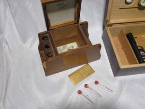 lot 91 image: VINTAGE PIPE RACK &amp TABACCO STORAGE BOX A PIPE INCLUDED &amp ZIPPO INSERTS, CIGAR HUMIDOR BOX W GAUGES, 2 CIGAR CASES &amp CUTTER