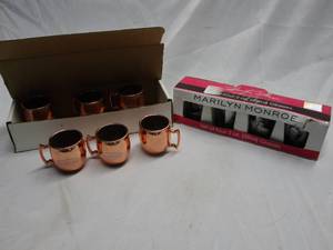 lot 339 image: SOBIESKI VODCA MOSCOW MULE MUGS IN BOX, SET OF 4 MARILYN MONROE 2OZ GLASSES NEW IN BOX, BOX SLIGHTLY DAMAGES. SEE PICS.