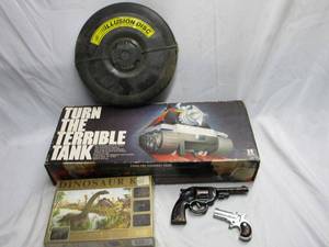 lot 361 image: DINOSAUR FOSSIL EXCAVATION KIT NEW IN BOX. VINTAGE METAL CAP GUNS, DERRINGER.ILLUSION DISC. VINTAGE TURN THE TERRIBLE TANK GAME IN BOX.
