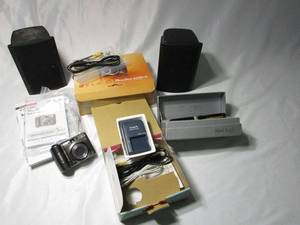 lot 381 image: CANON POWERSHOT A590 IS IN ORIGINAL BOX WITH CORDS, BATTERY CHARGER, AND MANUALS. SAMSUNG DIGITAL RECORDER VOICE PEN WITH CHARGER IN BOX. 2 YAMAHA SPEAKERS.