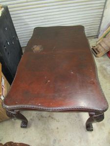 lot 58 image: MAHOGONY TABLE ROUGHLY 6.5 FT WITHOUT ADDING LEAF. LEAF ADDS APPROXIMATELY 18. SOME SCUFFS AND SCRAPES BUT GOOD CONDITION OVERALL. MATCHING CHAIRS LOT 565