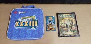 lot 24 image: Lot of Super Bowl XXXIII Collectibles - Seat Cushion, Offical Game Program, and Commemorative Coin