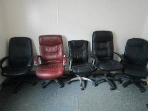 lot 204 image: 5 rolling office chairs 4 black 1 brown leather 1 black one is a power message chair missing plug unknown working condition