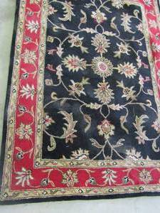 lot 8 image: Sofi Black and Red area rug 5x7