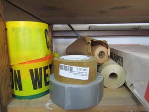 lot 63 image: tape WET PAINT, tape, plus paper rolls and box of packing paper