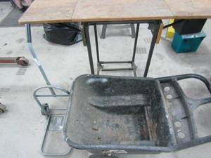 lot 15 image: Workbench on wheels with wood top that extends on both sides 40T 23 when folded extends to50 plus yard cart plastic wheelbarrow and a luggage cart