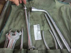 lot 29 image: Mercedes Benz brand fabric caddy with various car tools (wrenches, pliers, and lugnut wrench)