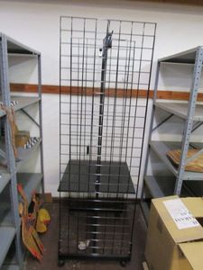 lot 36 image: BLACK METAL GRID RETAIL RACK ON WHEELS.&nbsp INCLUDES SOME HANGING HOOKS.&nbsp