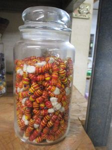 lot 129 image: GLASS JAR FILLED WITH BEADS