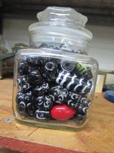 lot 159 image: GLASS JAR FILLED WITH BLACKWHITE PAINTED BEADS.
