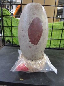 lot 202 image: SHIVA LINGHAM STONE WITH HAND WEAVED STRAW BASE. STONE IS MADE OF CRYPTO-CRYSTALLINE QUARTZ.&nbsp