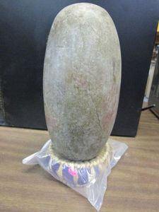lot 205 image: SHIVA LINGHAM STONE WITH HAND WEAVED PURPLE STRAW BASE. STONE IS MADE OF CRYPTO-CRYSTALLINE QUARTZ.&nbsp