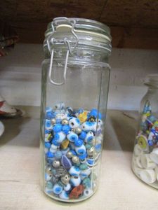 lot 209 image: AIR TIGHT GLASS JAR WITH BEADS