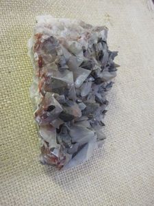 lot 412 image: DOGTOOTH CALCITE CRYSTAL CLUSTER W HEMATITE PHANTOMS