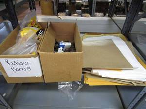 lot 304 image: OFFICE SUPPLIES- BOX OF RUBBER BANDS, BOX OF STAPLES AND STAPLE REMOVERS, AND MISC SIZES OF MANILA ENVELOPES.&nbsp