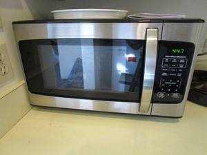 lot 69 image: WORKING MICROWAVE, GLASS TRAY INSIDE &amp PLASTIC COVER