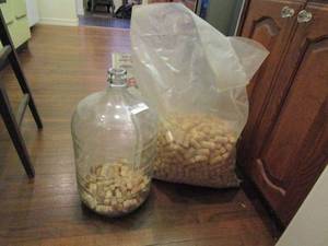 lot 195 image: GLASS 5 GAL JUG WITH CORKS INSIDE &amp LARGE BAG OF CORKS