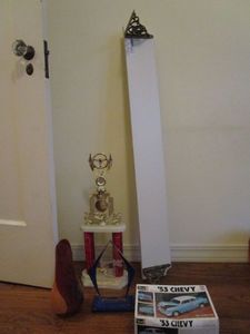 lot 72 image: WOODEN SHELF- ROUGHLY 36, WOODEN VASE, 2 AWARDS, 53 CHEVY MODEL CAR