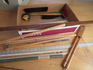 lot 143 image: BOX OF STRAIGHT EDGE RULERS, LG PROTRACTOR, TAPE MEASURE, BRUSHES, SPEED SQUARE, FLEXICURVE DRAWING TOOL