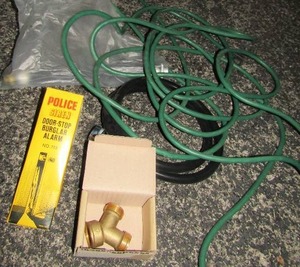 lot 25 image: Extension cord, Police door stop, plumbing hardware