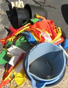 lot 41 image: Lot- flower pots, buckets, flag banner, oil drip pan, metal tree dcor wine holder