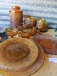 lot 67 image: Amber color glassware set-3 plates, platter, 2 sorbet, 2 mugs, 1 goblet, 3 cannisters (1 with lid)