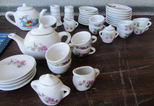 lot 105 image: 2 mini tea sets, tea cups, saucers, cream & sugar, one spoon, 2 teapots