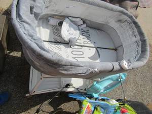 lot 143 image: Gray baby bassinet and 2 baby bouncers