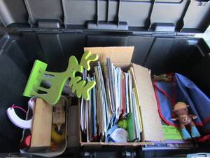 lot 228 image: Black plastic chest for tools full of childrens toys and books