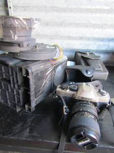 lot 230 image: Nikon FM 10 camera 200m and flash, case, & Lenses plus starry night celestial kit