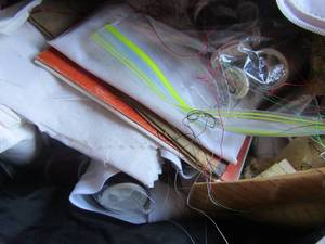 lot 254 image: White duffel bag full of sewing notions ( needles, thread, patterns, scissors, etc.)