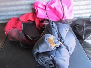 lot 271 image: Large red duffle bag.  pink tote bag and sleeping bag